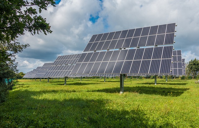 Solar panels in China with a coal power plant in the background, symbolizing the country’s transition from coal to renewable energy under the new Energy Law.